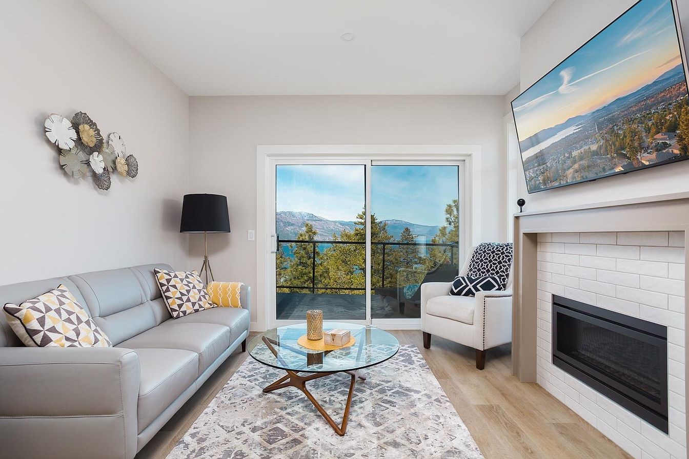 Living room with gas fireplace and lake view